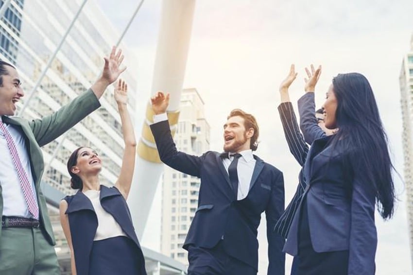 Office workers celebrating with a high-five